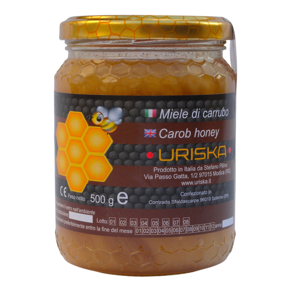 miele di carrubo di colore nocciola-ambrato con venature di nocciola chiaro